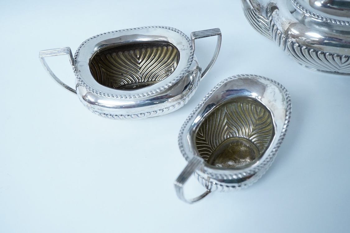 A late Victorian demi-fluted silver oval three piece bachelor's tea set, by James Deakin & Sons, Chester, 1893, gross weight 15.7oz.